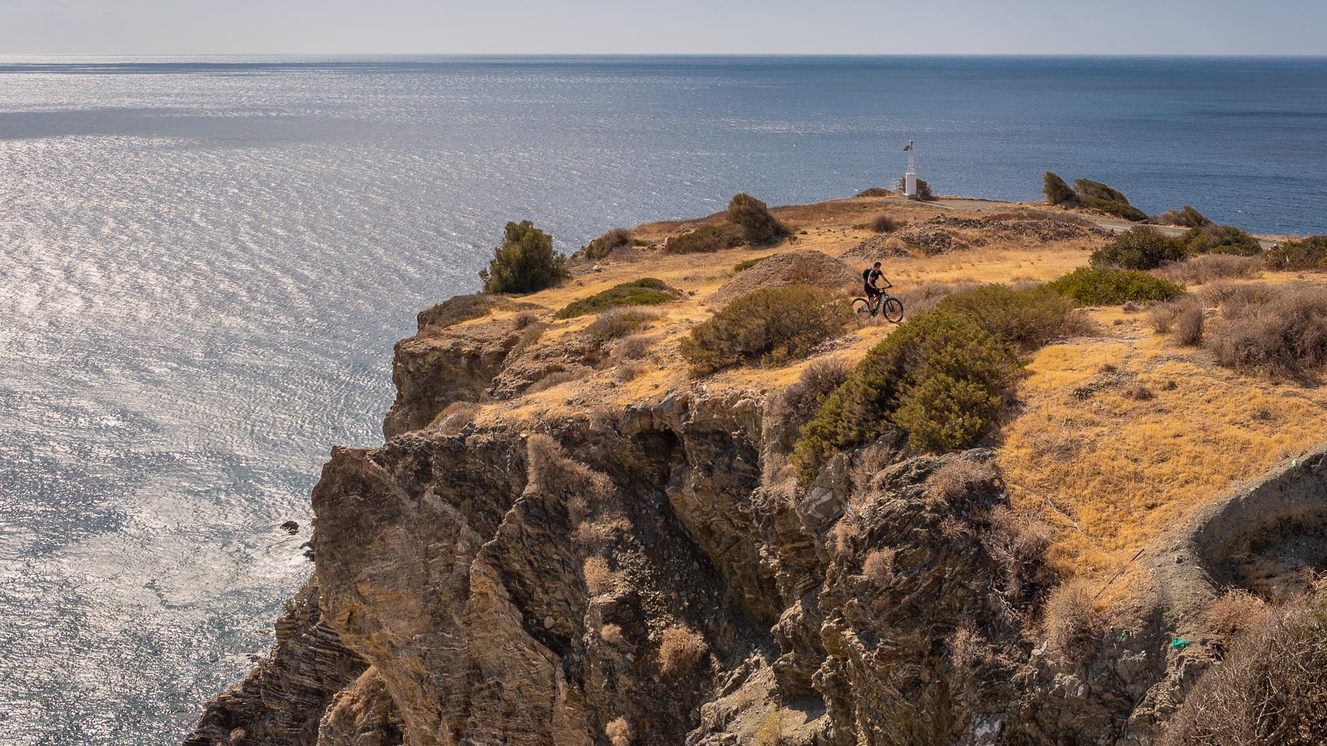 an e biker looks out over the sea from a mountain on the Greek main island