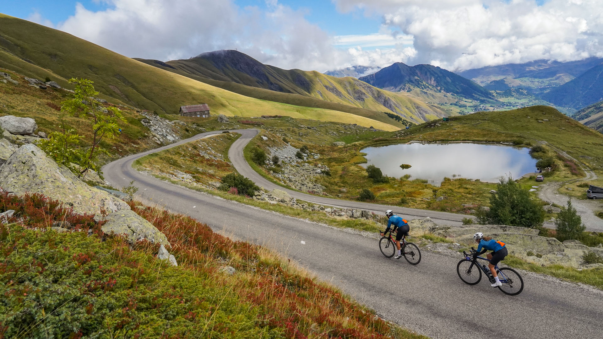 Descending the Croix de Fer with scenic views on the Aiguilles d'Arve