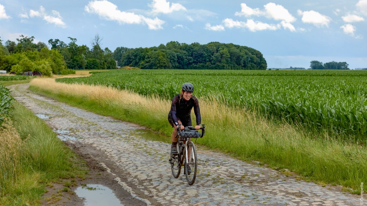 cyclist riding along a cobbled sector near Trouee d'Arenberg