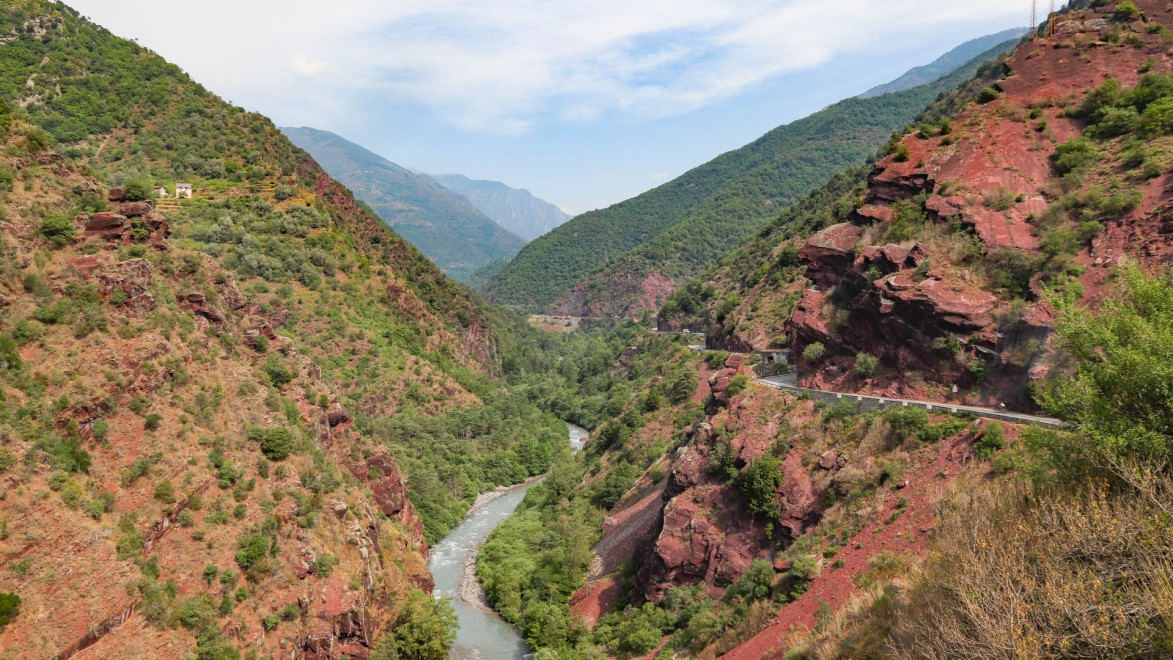 two road cyclists riding the red ochre gorges du Cians and gorges du Daluis